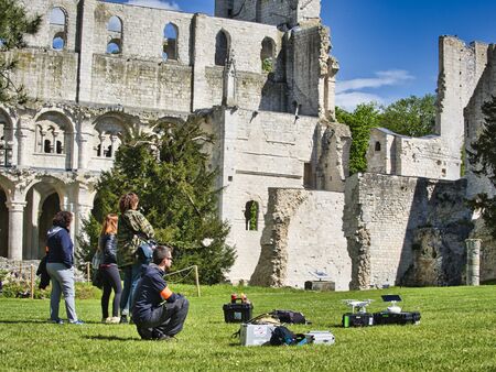 JUMIEGES, FRANCE - April circa, 2019. Unidentified camera men for professional movie. . Back angle view of high definition digital video camera which recording or shooting tv commercial production on pan tilt shift professional head tripod at outdoor locaのeditorial素材
