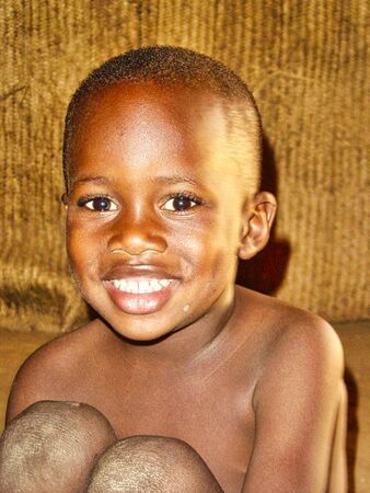 TIMBUKTU, MALI - February circa, 2019. Unidentified Malian boy smiles and poses in the street in...