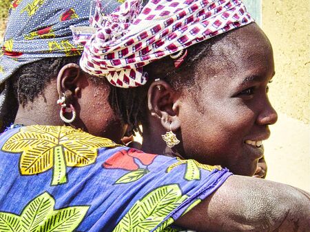 TIMBUKTU, MALI - FEBRUARY Circa, 2019. Unidentified poor african children girls shy and curious to see tourists. Dressed with colorful traditional clothesのeditorial素材