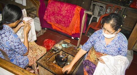 BALI, INDONESIA - FEBRUARY Circa, 2019. Unidentified Woman indonesian painting Batik. Balinese...