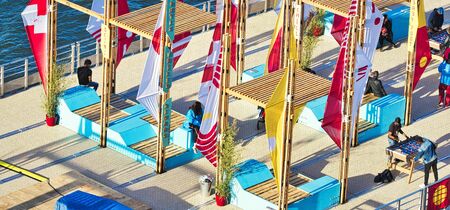 ROUEN, FRANCE - JUNE 8, 2019. Colorful wooden terrace with table, chairs and flags, ready for a street cafe or restaurant, during the Aramda time, international meeting for sailboats. Aerial viewのeditorial素材