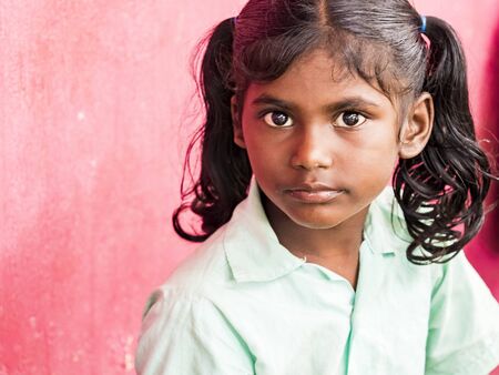 PUDUCHERY, INDIA - DECEMBER Circa, 2018. Portrait of unidentified handsome cute smiling indian girl outdoors. Concept of joyful even if they are poor people.のeditorial素材