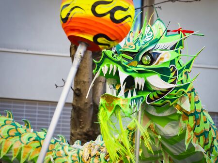 PARIS, FRANCE - FEBRUARY 17, 2019. Last day of the chinese new year celebration festival in street. Dance of colorful green dragons in the street during the parade festival. Close up head of dragon. Traditional celebration.のeditorial素材