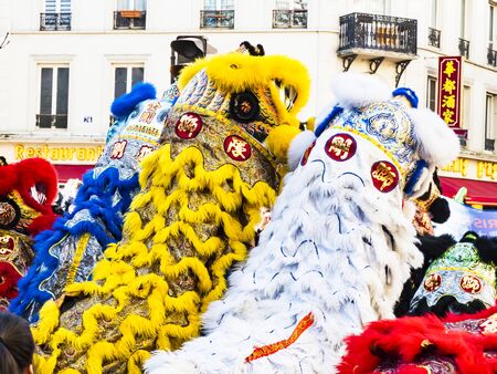PARIS, FRANCE - FEBRUARY 17, 2019. Last day of the chinese new year celebration festival in street. Dance of colorful lions decoration masks in the street during the parade festival. Traditional celebration.のeditorial素材