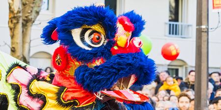 PARIS, FRANCE - FEBRUARY 17, 2019. Last day of the chinese new year celebration festival in street. Dance of colorful lions decoration masks in the street during the parade festival. Traditional celebration.のeditorial素材