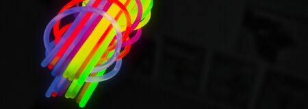 New colors of glow sticks for night party, on black background. Panoramic banner sizeの写真素材