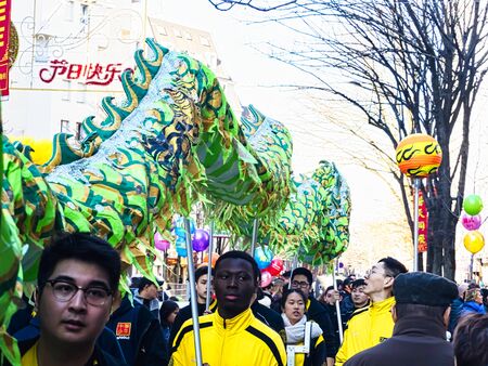 PARIS, FRANCE - FEBRUARY 17, 2019. Last day of the chinese new year celebration festival in street. Dance of colorful green dragons in the street during the parade festival. Traditional celebration.のeditorial素材