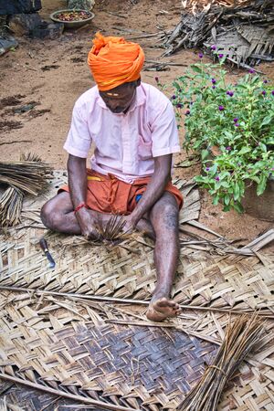 PUDUCHERRY, TAMIL NADU - DECEMBER Circa, 2018. Unidentified Indian worker preparing the leaves to...