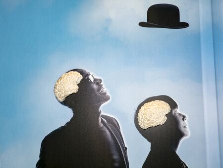 SCIENCE CENTER, PARIS, FRANCE - NOVEMBER Circa, 2019. Silhouette of two men and a brain inside head...