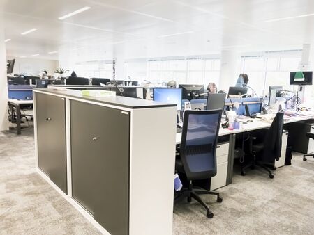 PARIS, FRANCE - NOVEMBER Circa, 2019. Exciting boardroom meeting with people at desk with computer in trendy office space, at Europe 1, radio recording studio.のeditorial素材
