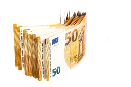 Concept of financial impact of covid-19 on European money area. Pack of fifty euros bills on white...