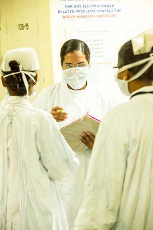 Puducherry, India - March Circa, 2020. Nurses team speaking to each other in hospital hallway, Healthcare workers in the Coronavirus Covid19 pandemicのeditorial素材