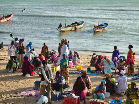 SENEGAL, AFRICA - MARSCH Circa, 2016. Scene of M'Bour great fish market on the beach. People waiting for the boat with fish.のeditorial素材