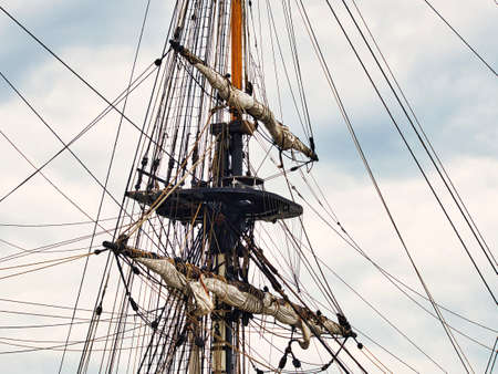 Vintage sailing ship mast ropes and tackle, Tall ship rigging mast detail, blue sky backgroundのeditorial素材