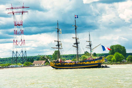 ROUEN, FRANCE - JUNE Circa, 2019. Hermione, famous replica of La Fayette Frigate on the Seine river for Armada exhibition. Built in Rochefort, three-masted frigate, 54 meters masts, 26 cannons firing