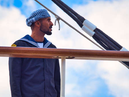 ROUEN, FRANCE - JUNE Circa, 2019. Unidentified attractive crew member with uniform on the top deck of a cruise ship schooner at Armada exhition in Franceのeditorial素材