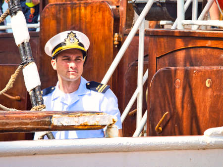 ROUEN, FRANCE - JUNE Circa, 2019. Unidentified attractive crew member with uniform on the top deck of a cruise ship schooner at Armada exhition in Franceのeditorial素材