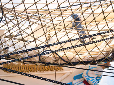 Nautical tackles and equipment of the old tall ship. Rigging ropes and rope ladder on the mast of sailing vessel as abstract background for your marine concept.のeditorial素材