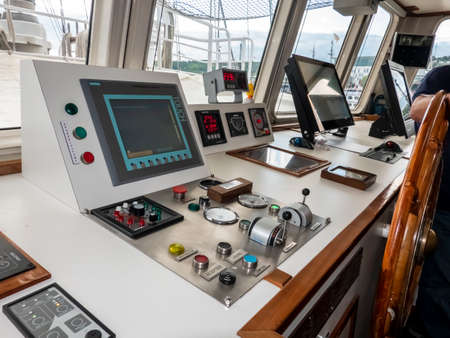 ROUEN, FRANCE - JUNE Circa, 2019. Wooden steering wheel and control panel on a old schooner at...