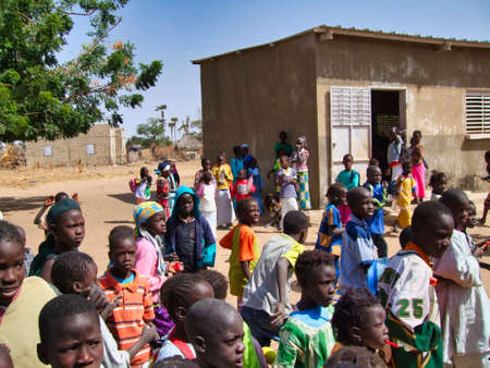 SENEGAL, AFRICA - MARSCH Circa, 2016. Unidentified portait of child african people who are very poor in Senegal. At school in the bush. Emotions on the face. Vibrant colorsのeditorial素材