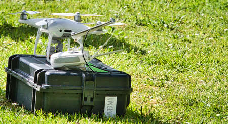 JUMIEGES, FRANCE - JUNE Circa, 2019. Mature male technicians outdoor, on grass, using professional drone to record french tv show, named La Carte Aux Tresors.のeditorial素材