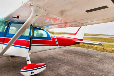 CAEN, FRANCE - JUNE Circa 2016 - Part of small plane on aiport field. CESSNA Blue white Red, with...