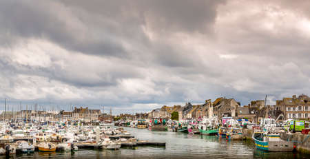SAINT VAAST, FRANCE - SEPTEMBER Circa, 2020. Dramatic cloudy Sky landscape on the harbor with sailboats. Panorama, dark pessimist atmosphere feelingsのeditorial素材