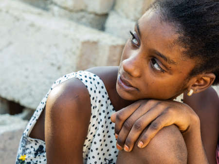 MBOUR, SENEGAL - JANUARY Circa, 2021. Portrait of unidentified young senegalese children, not looking at camera. Beautiful skin, hairs, light. outdoorsのeditorial素材