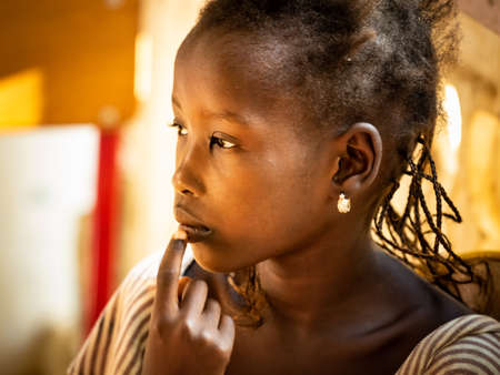 MBOUR, SENEGAL - JANUARY Circa, 2021. Close up unidentified upset thoughtful African teenage girl...