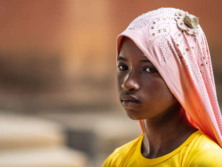 MBOUR, SENEGAL - JANUARY Circa, 2021. Unidentified child girl with sad anxious face, thinking about...