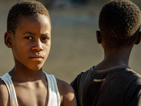 MBOUR, SENEGAL - JANUARY Circa, 2021. Unidentified child boy with sad anxious face, thinking about way of life in poor african village.のeditorial素材
