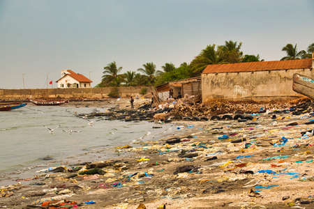 WARANG, MBOUR, SENEGAL - Circa JANUARY 20222. Beach sand of atlantic ocean with so many garbage plastic pollution in Senegal Africa. No place for tourism on beach to enjoy holidaysの写真素材