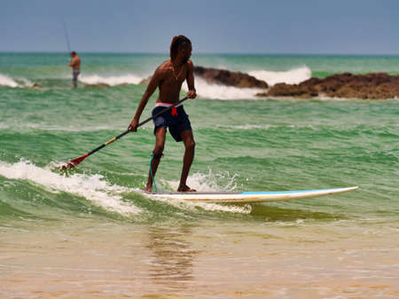 SOMONE, SENEGAL - NOVEMBER Circa, 2021. Unidentified beginner surfers on sea , trying to find good easy wave. At sunset time. Very good lights.のeditorial素材