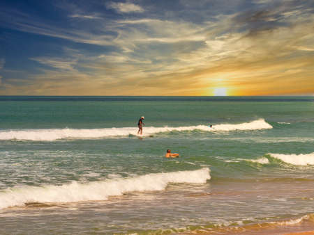 SOMONE, SENEGAL - NOVEMBER Circa, 2021. Unidentified beginner surfers on sea , trying to find good easy wave. At sunset time. Very good lights.のeditorial素材