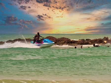 SOMONE, SENEGAL - NOVEMBER Circa, 2021. Unidentified beginner surfers on sea , trying to find good...