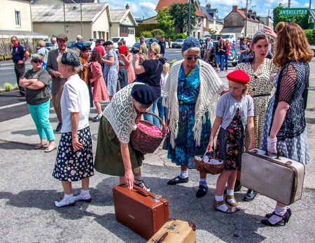 SAINTE MERE L'EGLISE, FRANCE - JUNE 6, 2019. Parade of People dressed up in 1940's clothing posing in front of a World War 2, D-Day ceremony in Normandy. People found liberty after 5 years war. happy day memorialのeditorial素材