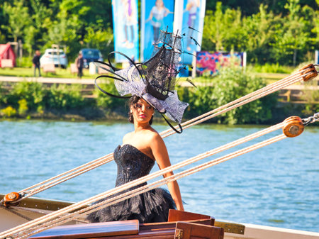 ROUEN, FRANCE - JUNE Circa, 2019. Portrait of the beautiful elegant luxury brunette model wearing a hat which stands on a schooner at Armada exhibition in Franceのeditorial素材