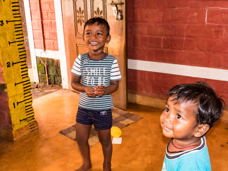 PUDUCHERY, INDIA- DECEMBER Circa, 2018. Unidentified children playing with toys balloon on the floor of the children's room. Poor children with very simple wooden balloon games.のeditorial素材