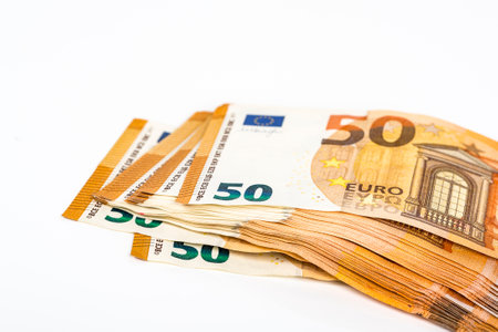 a lot of euro banknotes on white. 50 euros on the table. Money background. Close up. Selective...