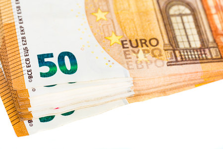 a lot of euro banknotes on white. 50 euros on the table. Money background. Close up. Selective...