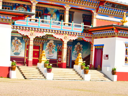 LA BOULAYE, FRANCE - APRIL Circa, 2018. Large outdoor view of the famous One thousand buddhas temple. It is multi-colored, three-tiered Bhutanese style with statues of Buddhas of various sizes, many Thangka paintings, wall frescoes and friezesのeditorial素材