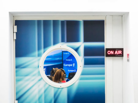 PARIS, FRANCE - NOVEMBER Circa, 2019. ON AIR board message is lit on the door of the recording studio, with circle window with Europe 1 logo, french famous radioのeditorial素材