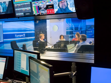 PARIS, FRANCE- NOVEMBER Circa, 2019. Technical room with audio mixing console, computers, tv led, screens and studio equipment in recording, broadcasting, editing studiio.のeditorial素材