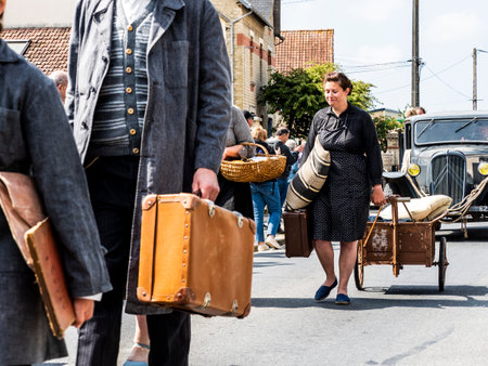 SAINTE MERE L'EGLISE, NORMANDY, FRANCE - JUNE 6 2023. Second world war commemoration. Unidentified vintage dressed rural families exodus due to war. Reenactment for birthday liberation.のeditorial素材