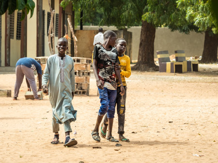 MBOUR, SENEGAL - CIRCA MARCH 2021. Unidentified group of happy smiling poor african children and teenagers looking at camera.のeditorial素材