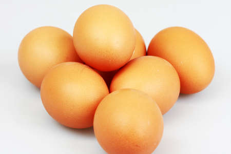 Pile of eggs on white backgroundの写真素材