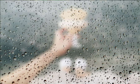 Background with rain drops close up. Rain drops on outdoor window, Closeup view transparent water drops on glass surface, humid water backdrop, blurred background with copy space for your textの写真素材