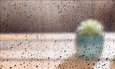 Background with rain drops close up. Rain drops on outdoor window, Closeup view transparent water drops on glass surface, humid water backdrop, blurred background with copy space for your textの写真素材