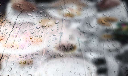 Background with rain drops close up. Rain drops on outdoor window, Closeup view transparent water drops on glass surface, humid water backdrop, blurred background with copy space for your textの写真素材