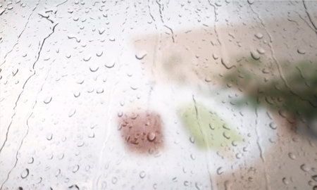 Background with rain drops close up. Rain drops on outdoor window, Closeup view transparent water drops on glass surface, humid water backdrop, blurred background with copy space for your textの写真素材